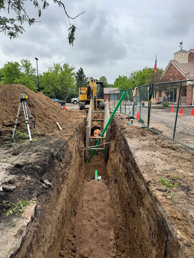 Residential utility trench with survey equipment