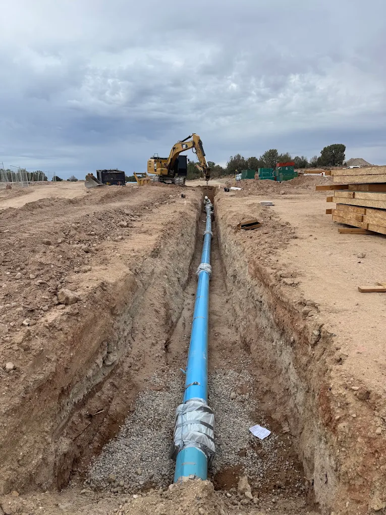 Blue water main pipe in trench